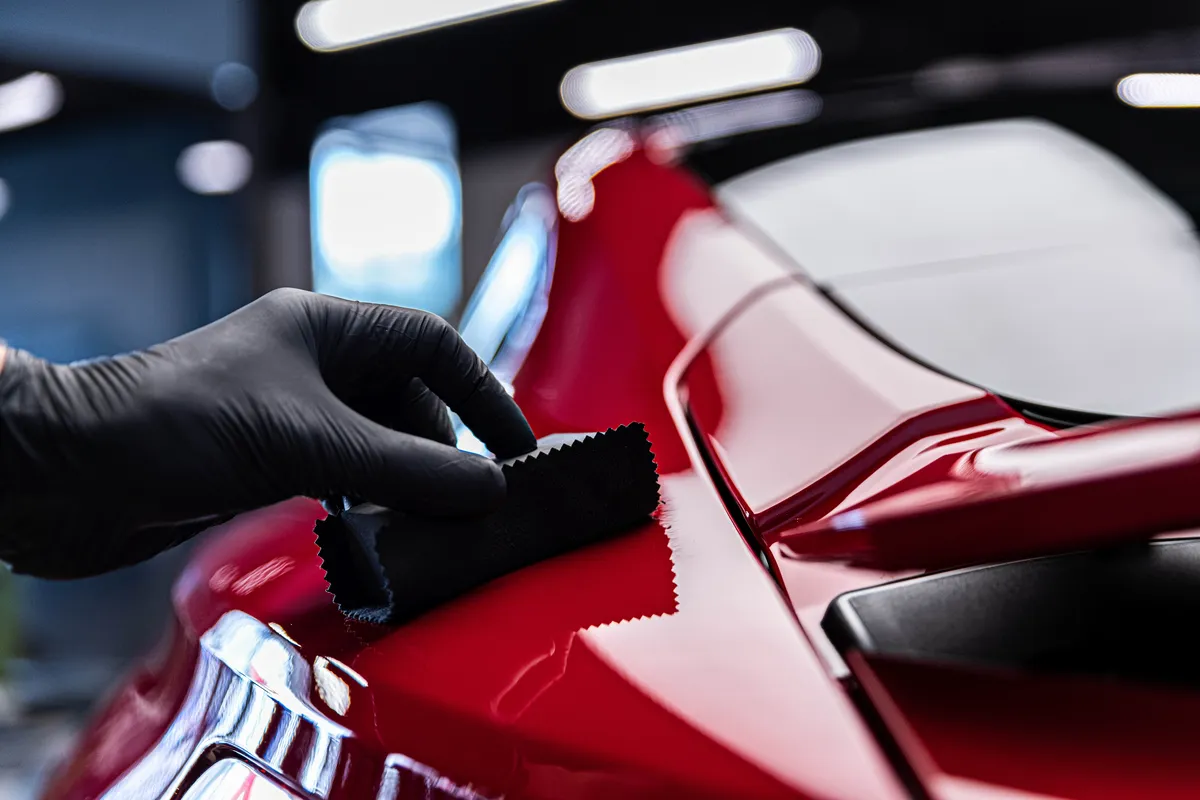 Ceramic Coating Being Applied to Red Porsche in Bellevue
